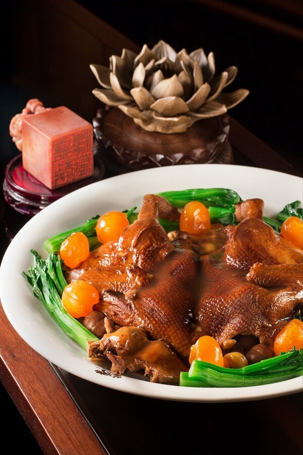 Braised half duck stuffed with assorted meat, mushrooms, beans and salty...